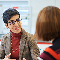 A member of staff helping a student