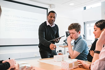 A teacher and several students in a classroom