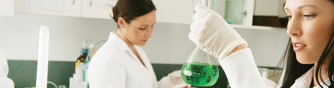 Student holding chemicals in a laboratory